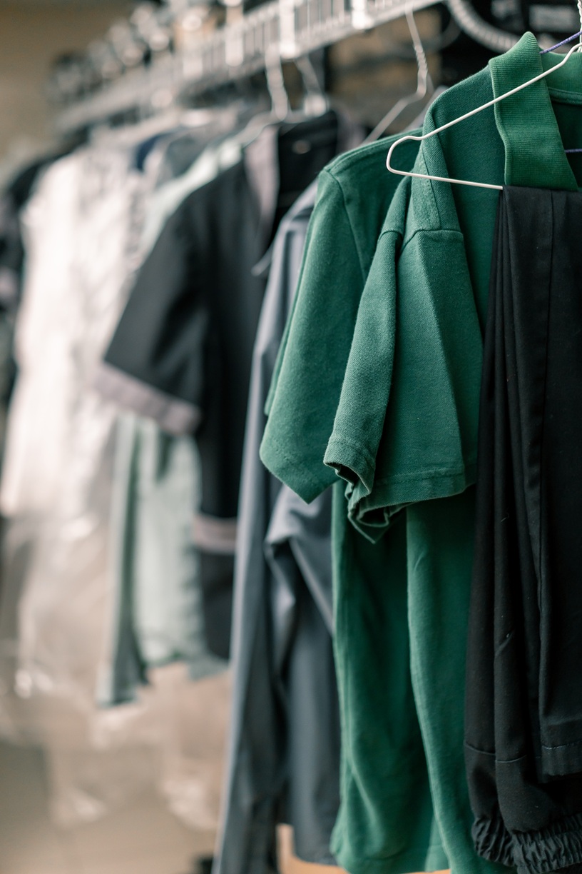 industrial laundry in the hotel clean shirts of employees and guests sorted after washing hang on clotheslines concept cleanliness and hospitality