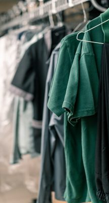 industrial laundry in the hotel clean shirts of employees and guests sorted after washing hang on clotheslines concept cleanliness and hospitality