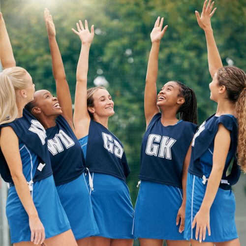 Netball, sports and motivation with a woman team in celebration after victory in a competitive game.